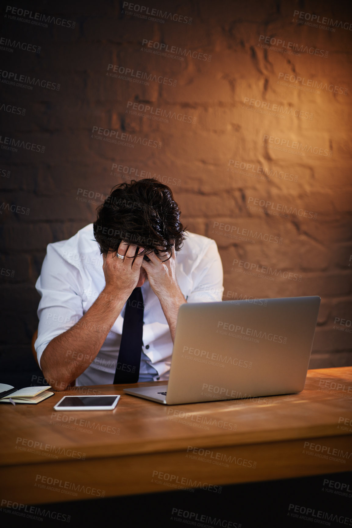 Buy stock photo Man, investigation or frustrated detective with stress, crisis or missing criminal report on laptop at night. Wall, tired or exhausted private investigator with evidence, headache or research mistake