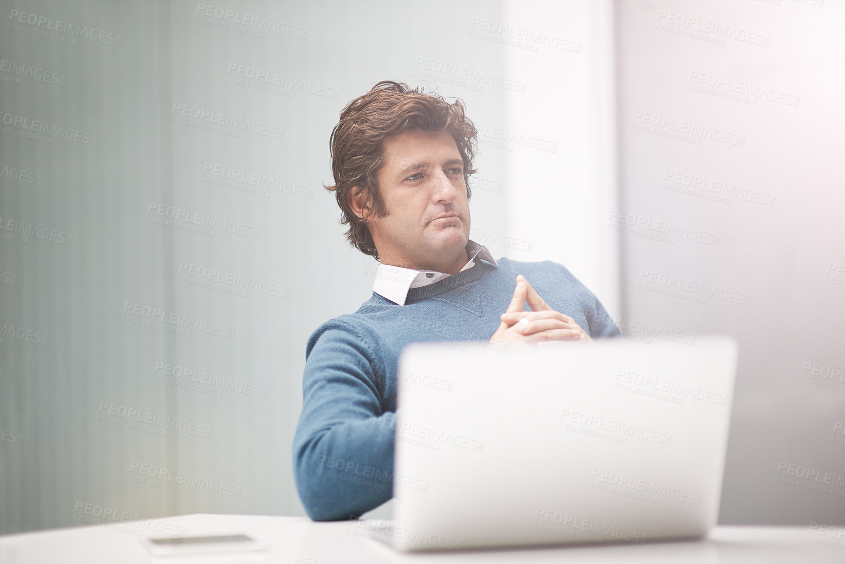 Buy stock photo Cropped shot of a businessman working on a laptop in an office