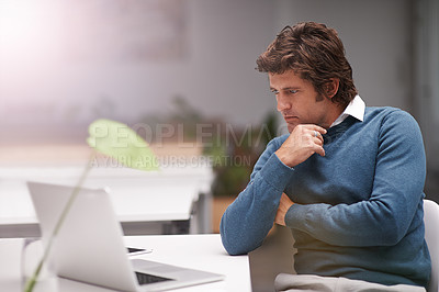 Buy stock photo Cropped shot of a businessman working on a laptop in an office