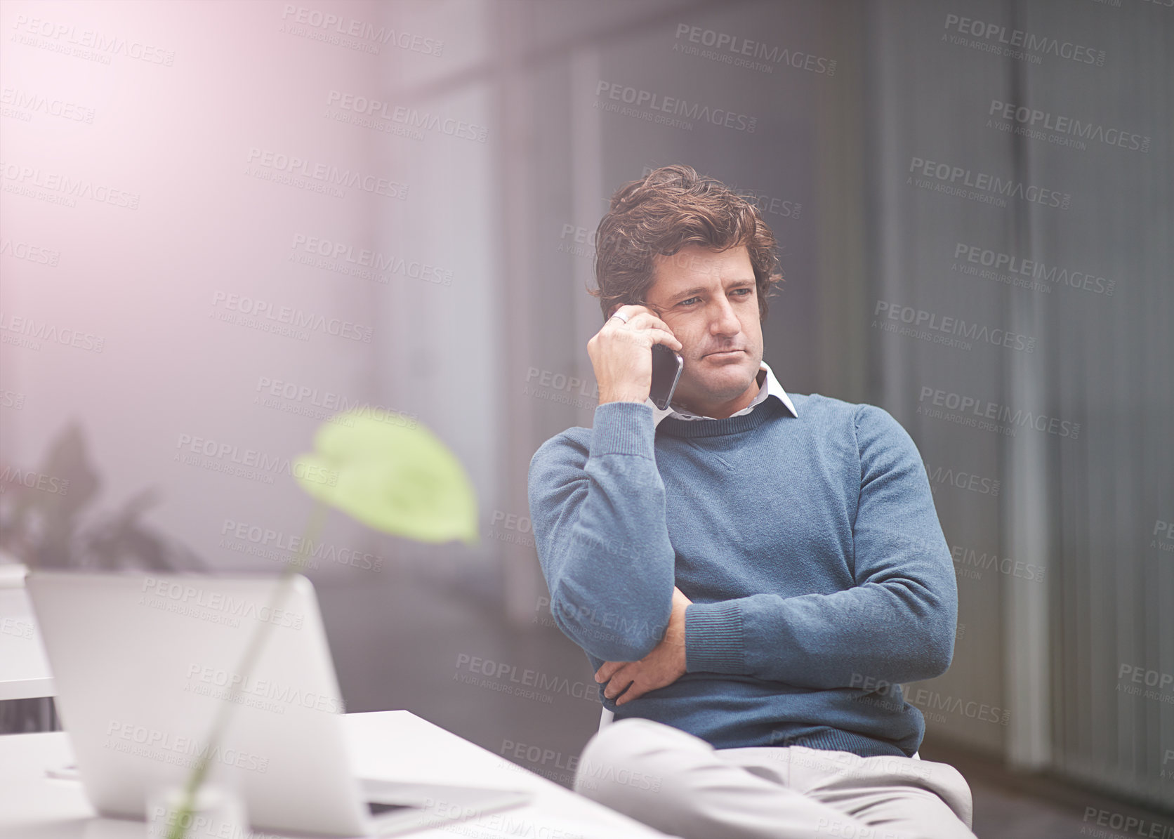 Buy stock photo Businessman, discussion and laptop with phone call for proposal, idea or creative startup at office. Serious man or young designer talking on mobile smartphone for business conversation at workplace