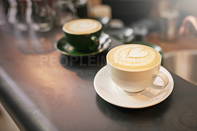 Buy stock photo Coffee on counter, cup and latte with art for creativity, cappuccino or caffeine drink with pattern. Warm beverage on table, foam and milk with heart or leaf design, hospitality and service at cafe