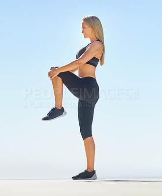 Buy stock photo Full length shot of a young woman stretching her legs outside