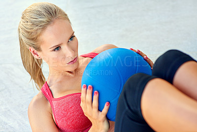 Buy stock photo Cropped shot of a young woman working out with a medicine ball