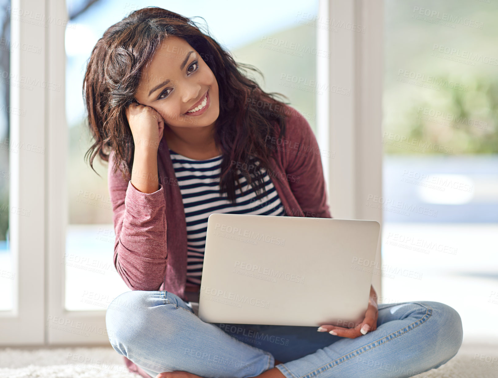 Buy stock photo Portrait of a young woman using her laptop while sitting on the floor