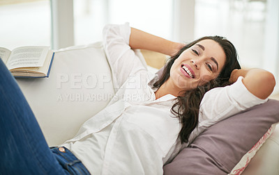Buy stock photo Portrait of a young woman lying on her sofa at home