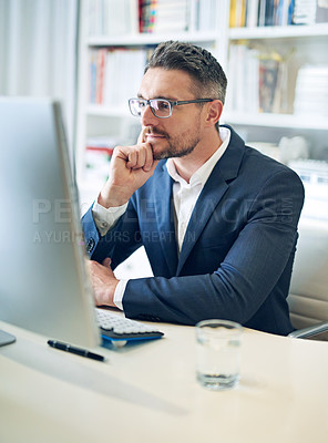 Buy stock photo Cropped shot of a businessman working on his laptop in his office