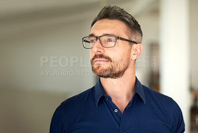 Buy stock photo Cropped shot of a man standing in his home looking thoughtful