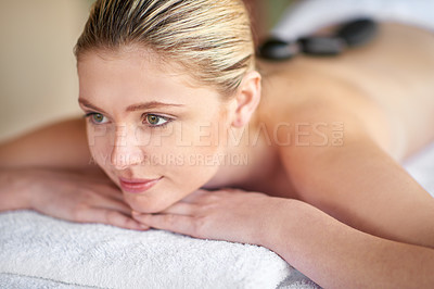 Buy stock photo Shot of a young woman having a lastone treatment at the spa