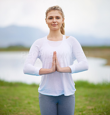 Buy stock photo Shot of a young woman doing yoga in the outdoors