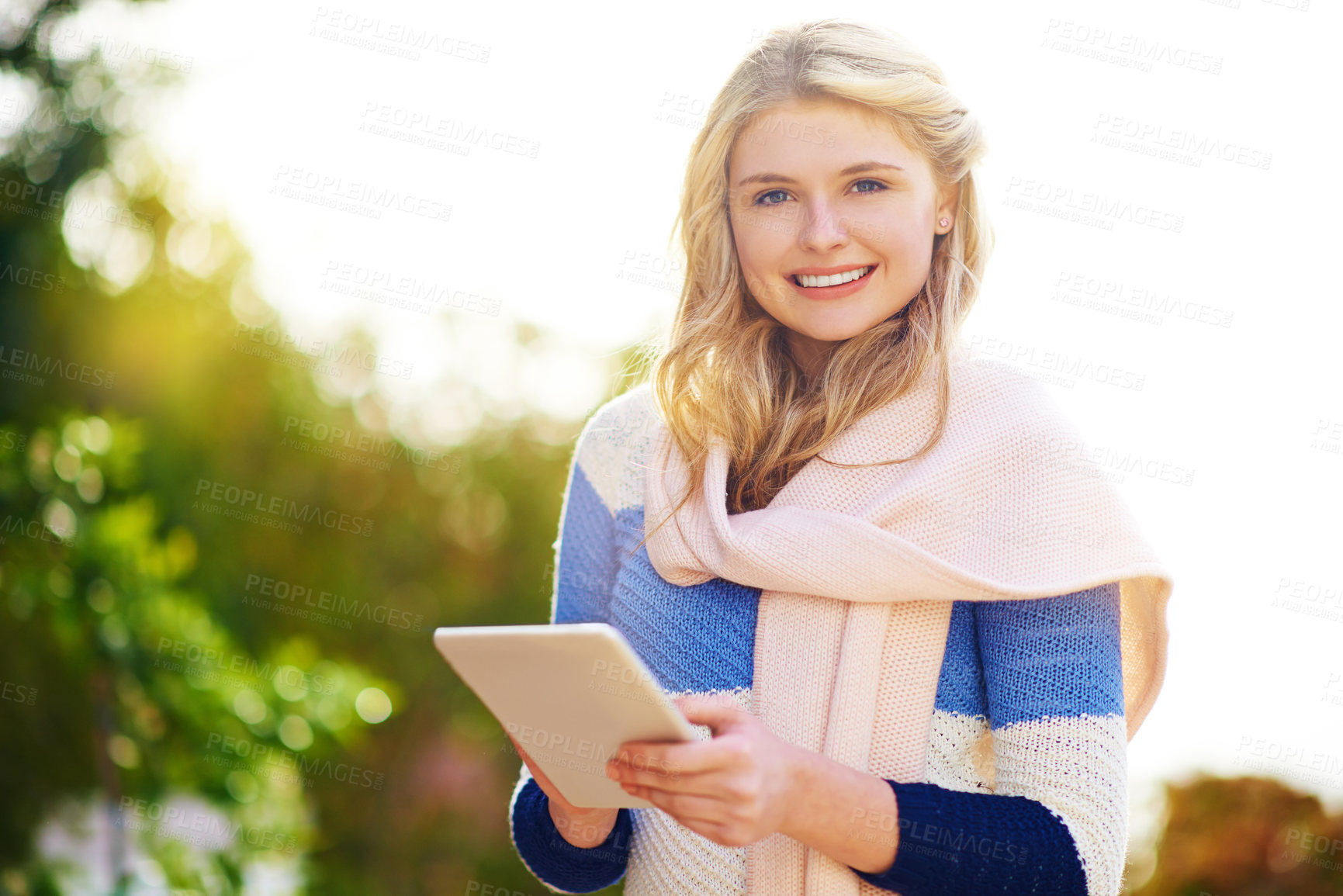 Buy stock photo Woman, tablet and portrait in park for chat, communication and waiting for meet up from online dating profile. Gen z girl, tech and happy outdoor for notification, networking and update in winter