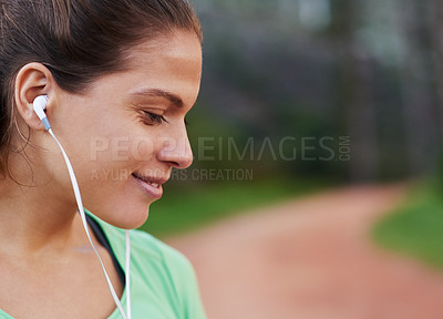 Buy stock photo Woman, earphones and smile for fitness, exercise and wellness with music in park. Runner, headphones and happiness for training, performance and cardio health with audio in countryside outdoor
