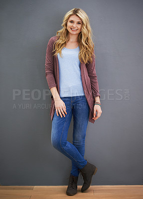 Buy stock photo Portrait of a young woman standing against a gray background