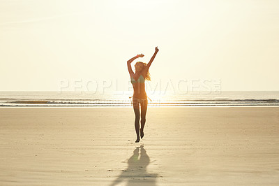 Buy stock photo Portrait of an attractive young woman running on the beach