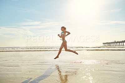 Buy stock photo Shot of an attractive young woman on the beach