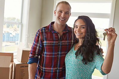 Buy stock photo Shot of a young couple moving into their new home