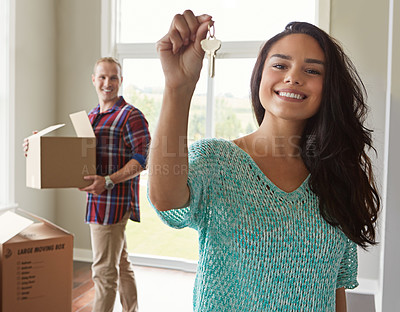 Buy stock photo Shot of a young couple moving into their new home