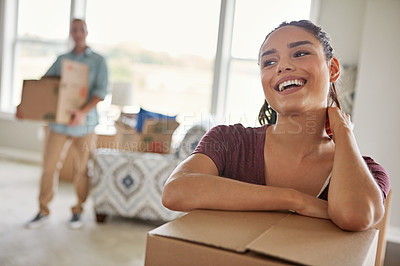 Buy stock photo Shot of a young couple moving into their new home