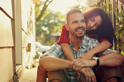 Buy stock photo Cropped shot of a young woman embracing her boyfriend from behind