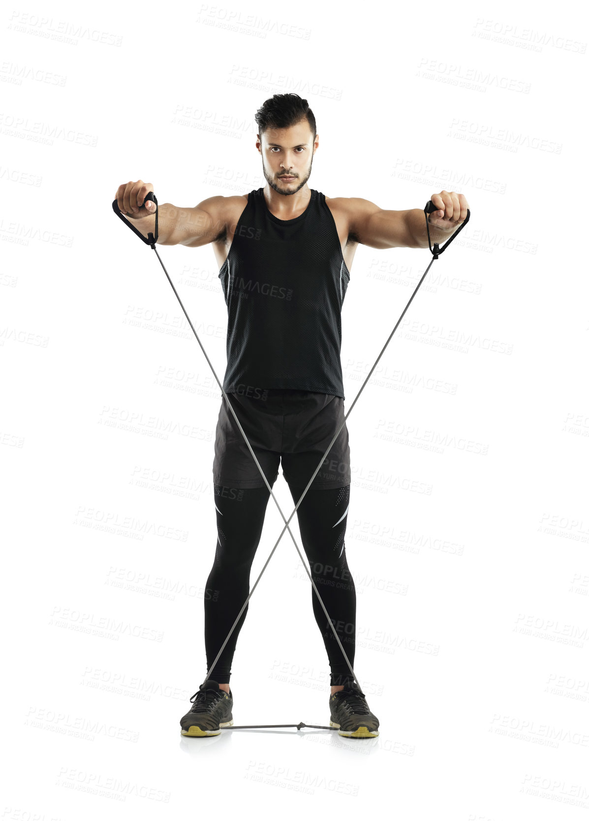 Buy stock photo Studio shot of a young man working out with a resistance band against a white background