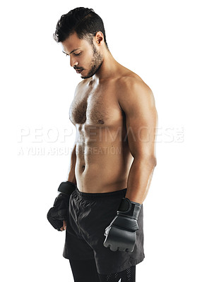 Buy stock photo Studio shot of a fit young man wearing boxing gloves against a white background