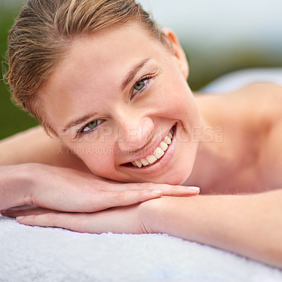Buy stock photo Spa, portrait and woman lying on massage bed for wellness, beauty treatment or body care. Smile, relax and happy person at luxury resort for stress relief, comfort or pamper on tropical holiday