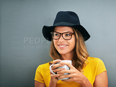Buy stock photo Shot of a young woman drinking coffee against a gray background