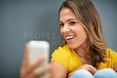 Buy stock photo Confident, woman and happy with selfie in studio for content creation, post and online blog. Relax, influencer and smile in photography for social media update, memory and pride on grey background