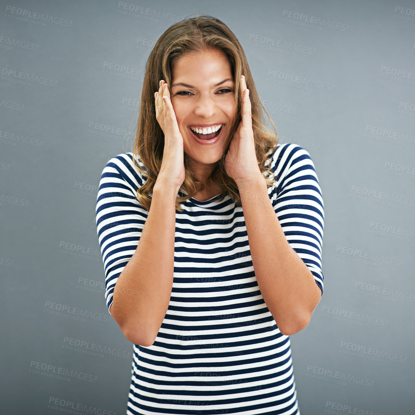 Buy stock photo Woman, portrait and excitement with studio, ears covered and celebration for winner. Model, smile and happiness for good news, promotion and achievement with victory isolated on grey background