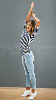 Buy stock photo Woman, happy and home fashion or relaxing, casual and carefree or stretch for portrait. Standing, grey wall and smiling in denim jeans with confident girl, weekend and comfort style or outfit