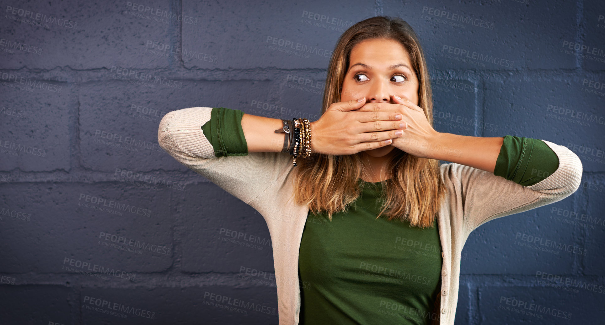 Buy stock photo Secret, woman and cover mouth by wall for quiet, confidentiality or communication. Gossip, drama and female person with hands on face for silence, hush or mute gesture by gray brick background.