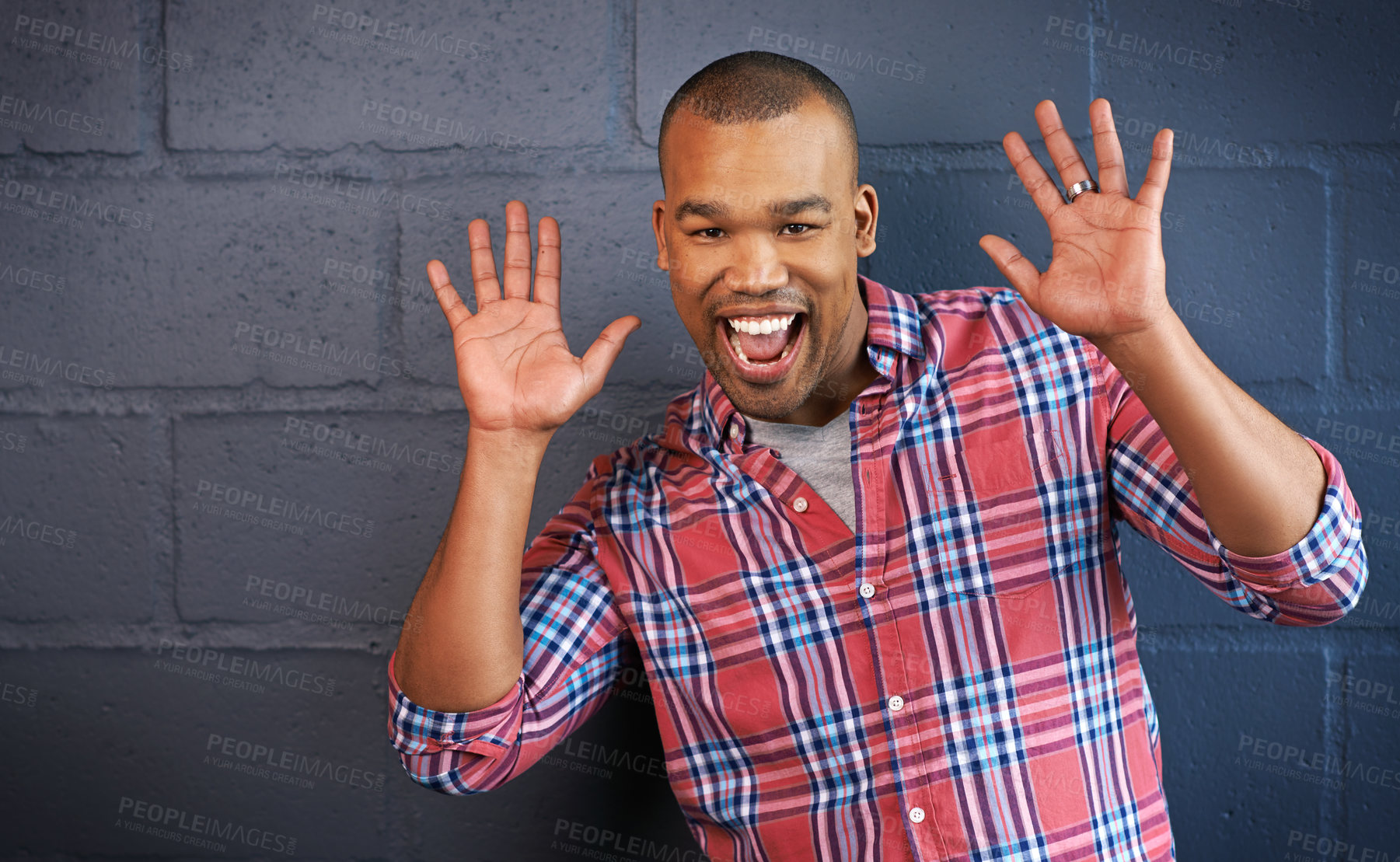 Buy stock photo Happy man, portrait and face with surprise for prize, news or expression on a gray brick wall background. Young male person or excited model with smile or friendly attitude in fun mood or enjoyment