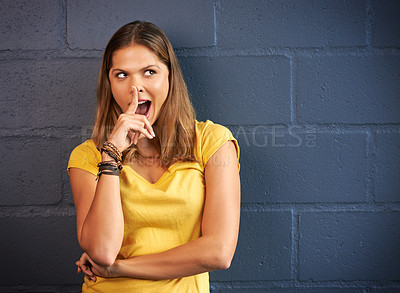 Buy stock photo Cropped shot of a young woman posing against a brick wall background