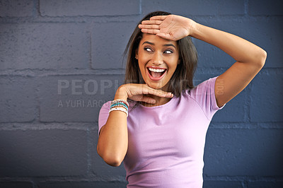 Buy stock photo Shot of a young woman gesturing with her hands against a brick wall background