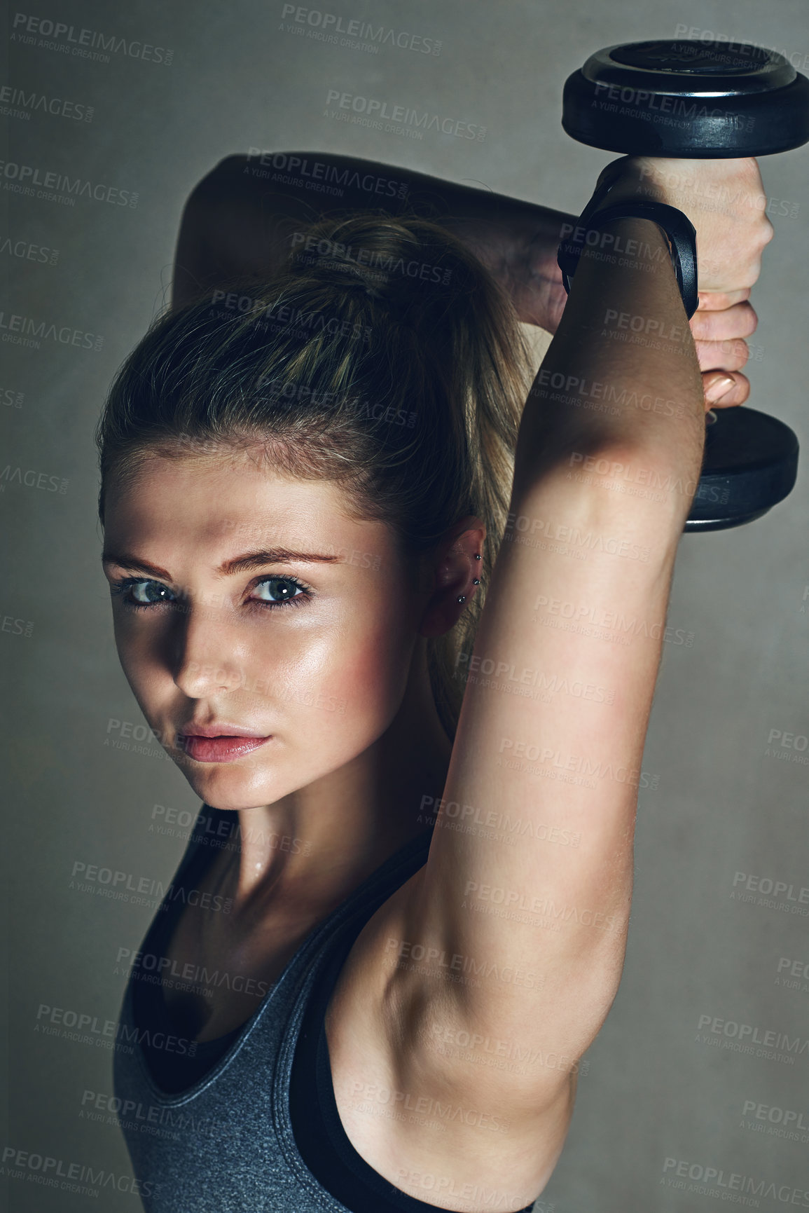 Buy stock photo Woman, dumbbell and training in studio portrait for muscle, growth or development by background. Girl, person and bodybuilder with equipment for exercise, fitness or workout for triceps with wellness