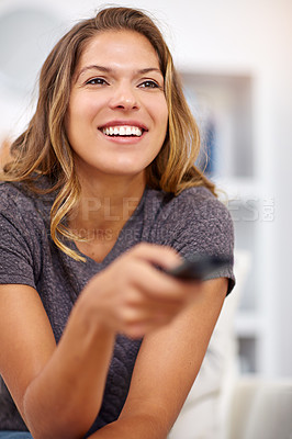 Buy stock photo Home, smile or happy woman watching tv or movie on online subscription or enjoying fun videos or news. Remote control, break or excited female person streaming film to relax in lounge or living room