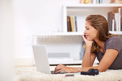 Buy stock photo Shot of a young woman using her laptop at home