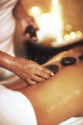 Buy stock photo Massage, hot stones and back for woman, hands and detox for treatment at spa or salon. Rocks, mind and body wellness for luxury service for female person, detox and relax for stress relief body care