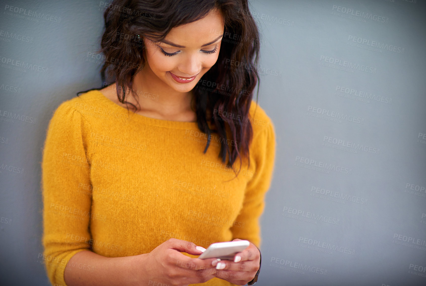 Buy stock photo Internet, happy and woman with phone in studio for social media, notification and online post. Smartphone, smile and female person with technology for contact, text message or chat on gray background