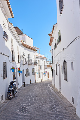 Buy stock photo Buildings, street and village with travel, architecture and blue sky for holiday with tourism or adventure. Culture, heritage and road with vacation, sightseeing and destination or location in Spain