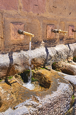 Buy stock photo Taps, holy water and city with old structure, wall and Ronda with spiritual cleansing, Andalusia and Spain. Empty, tourism and ablution with architecture, ritual and communal washing for ceremony