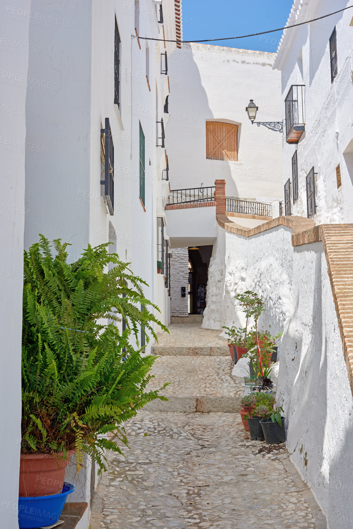 Buy stock photo Outdoor, houses and alley in neighborhood with traditional architecture in Spain. Outside, home and passage in village with cultural or vintage design as holiday or vacation destination for tourism