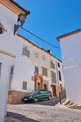 Buy stock photo Outdoor, houses and car in street with traditional architecture or neighborhood in Spain. Outside, home and road at village in cultural or vintage design as holiday or vacation destination in tourism