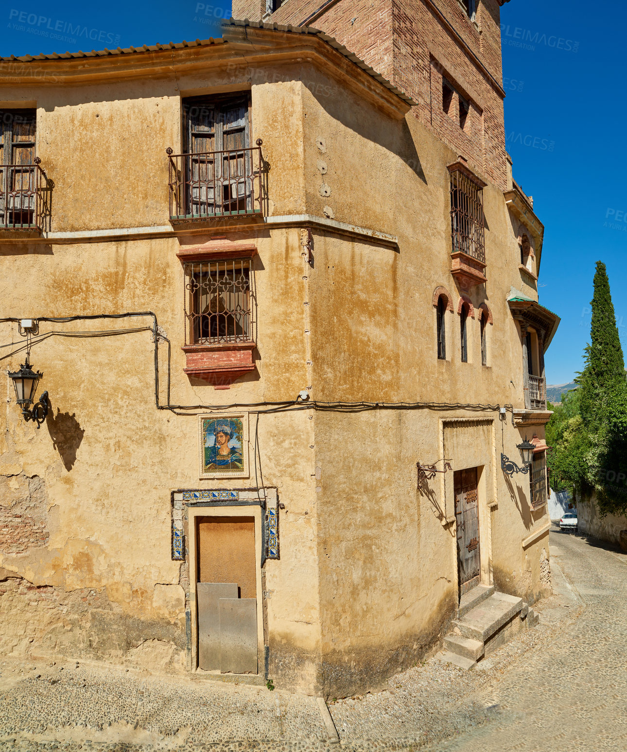 Buy stock photo Ancient, house and buildings architecture in city with wall structure, travel location and history tourism. Property, blue sky and window view, balcony fence and vintage neighborhood of Spain holiday