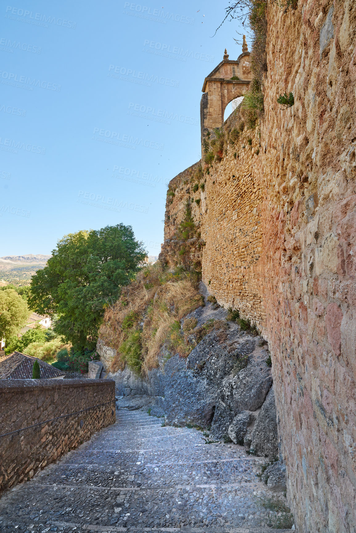 Buy stock photo Ancient, building and hill with steps architecture for wall structure, history location and culture monument. Pathway, stairs and colosseum museum with heritage travel, blue sky and vintage in Spain 