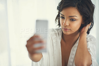 Buy stock photo Shot of a gorgeous young woman posing seductively for a selfie in her bedroom