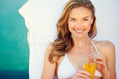 Buy stock photo Portrait of an attractive young woman enjoying a poolside drink