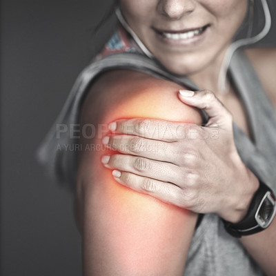 Buy stock photo Cropped shot of a young woman holding her injured shoulder that's highlighted in red