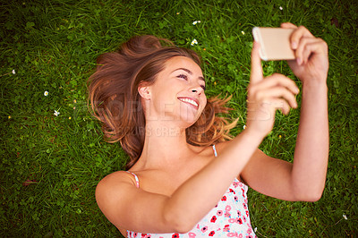 Buy stock photo Happy, selfie and woman on grass in nature for relax, fun and summer in outdoor park. Smile, calm and female person with photography picture on green in garden lawn in New Zealand from above.