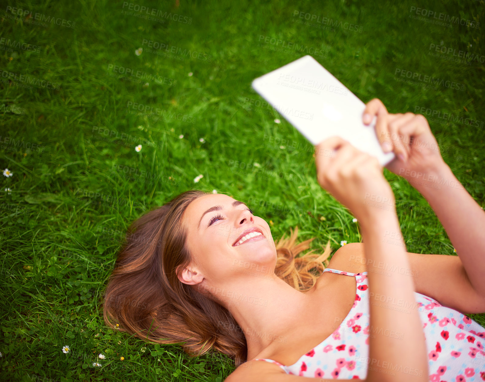 Buy stock photo Happy, reading and woman on grass for story, education and learning on university campus. College student, book and smile for literature, novel and research or relax in garden or field for assessment