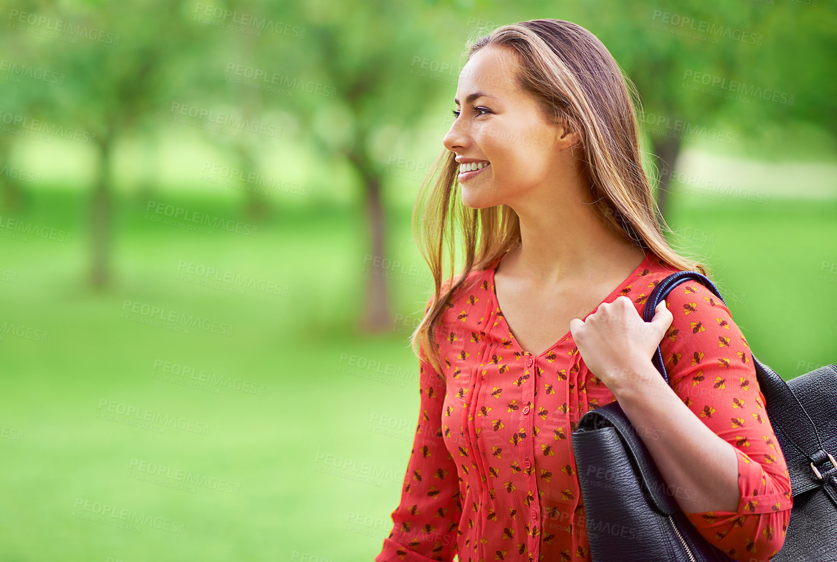 Buy stock photo Woman, walking and smile for travel in park, employee commute and happy in outdoor nature. Female person, thinking and professional for journey on trail to work, bag and ponder on trip to office